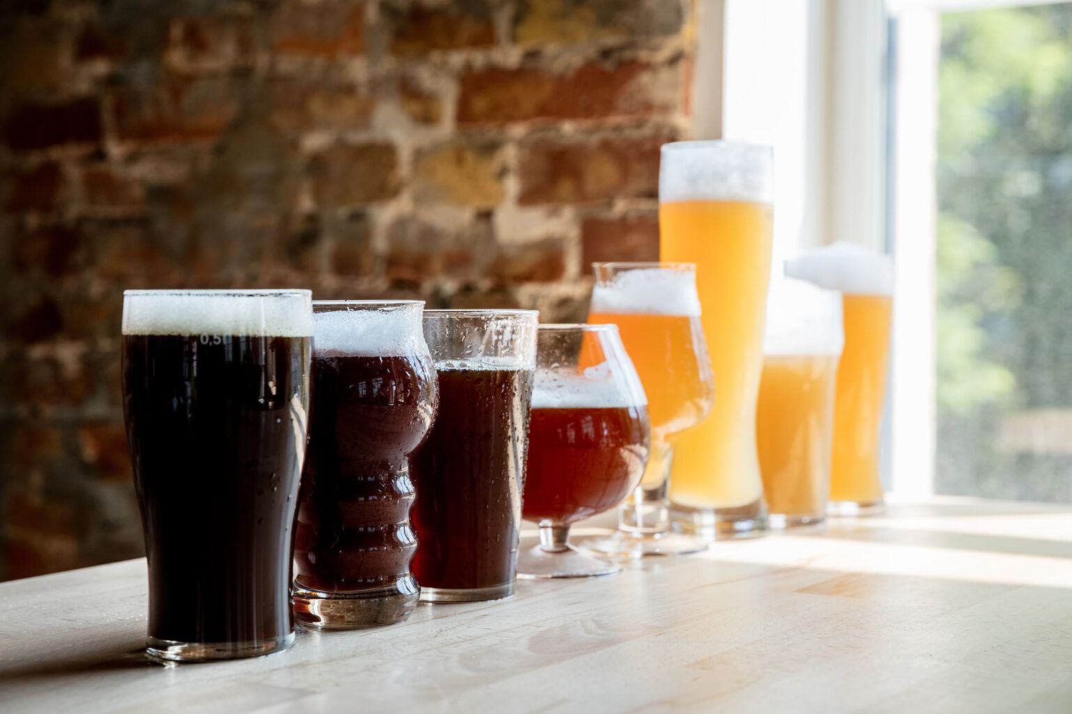 8 styles of beer are lined up from darkest to lightest color classification